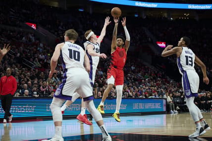 Dec 26, 2023; Portland, Oregon, USA; Portland Trail Blazers guard Anfernee Simons (1) shoots a jump shot against Sacramento Kings guard Kevin Huerter (9) during the first half at Moda Center. Mandatory Credit: Troy Wayrynen-USA TODAY Sports
