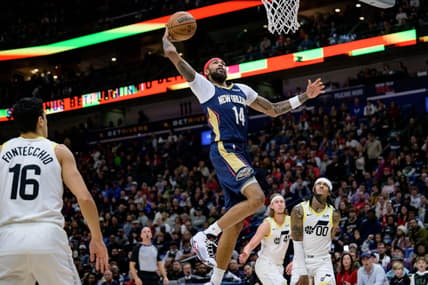 Dec 28, 2023; New Orleans, Louisiana, USA; New Orleans Pelicans forward Brandon Ingram (14) dunks against Utah Jazz guard Jordan Clarkson (00) during the first quarter at the Smoothie King Center. Mandatory Credit: Matthew Hinton-USA TODAY Sports
