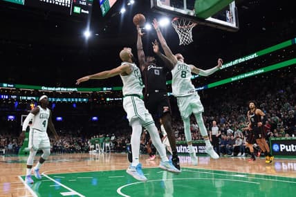 Dec 28, 2023; Boston, Massachusetts, USA;  Boston Celtics guard Derrick White (9) Detroit Pistons center Jalen Duren (0) and center Kristaps Porzingis (8) battle for a rebound during overtime at TD Garden. Mandatory Credit: Bob DeChiara-USA TODAY Sports