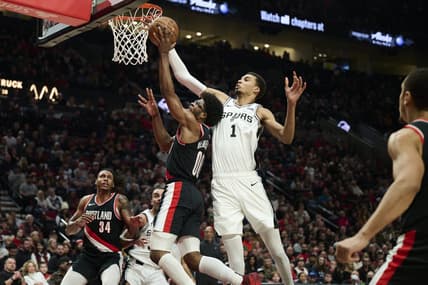 Dec 28, 2023; Portland, Oregon, USA; San Antonio Spurs center Victor Wembanyama (1) blocks a shot during the first half against Portland Trail Blazers guard Scoot Henderson (00) at Moda Center. Mandatory Credit: Troy Wayrynen-USA TODAY Sports