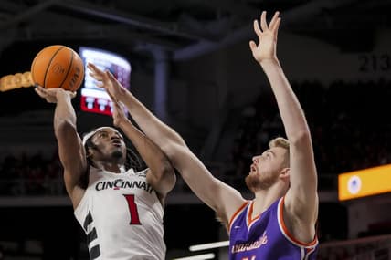 Dec 29, 2023; Cincinnati, Ohio, USA;  Cincinnati Bearcats forward Kalu Ezikpe (1) drives to the basket against Evansville Aces forward Joshua Hughes (11) in the first half at Fifth Third Arena. Mandatory Credit: Aaron Doster-USA TODAY Sports