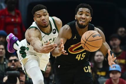 Dec 29, 2023; Cleveland, Ohio, USA; Milwaukee Bucks forward Giannis Antetokounmpo (34) and Cleveland Cavaliers guard Donovan Mitchell (45) go for a loose ball during the first half at Rocket Mortgage FieldHouse. Mandatory Credit: Ken Blaze-USA TODAY Sports