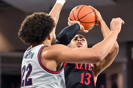 Dec 29, 2023; Spokane, Washington, USA; San Diego State Aztecs forward Jaedon LeDee (13) shoots the ball against Gonzaga Bulldogs forward Anton Watson (22) in the first half at McCarthey Athletic Center. Mandatory Credit: James Snook-USA TODAY Sports
