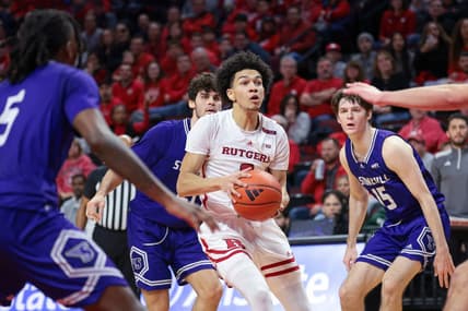 Dec 30, 2023; Piscataway, New Jersey, USA; Rutgers Scarlet Knights guard Derek Simpson (0) drives to the basket in front of Stonehill Skyhawks guard Josh Mack (5) and guard John O'Reilly III (15) during the first half at Jersey Mike's Arena. Mandatory Credit: Vincent Carchietta-USA TODAY Sports