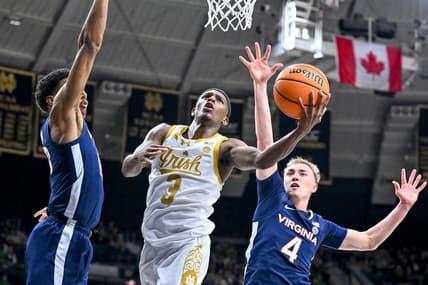 Dec 30, 2023; South Bend, Indiana, USA; Notre Dame Fighting Irish guard Markus Burton (3) shoots between Virginia Cavaliers guard Ryan Dunn (13) and guard Andrew Rohde (4) in the first half at the Purcell Pavilion. Mandatory Credit: Matt Cashore-USA TODAY Sports