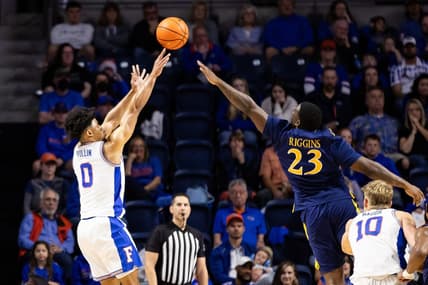 Dec 30, 2023; Gainesville, Florida, USA; Florida Gators guard Zyon Pullin (0) shoots over Quinnipiac Bobcats forward JJ Riggins (23) during the first half at Exactech Arena at the Stephen C. O'Connell Center. Mandatory Credit: Matt Pendleton-USA TODAY Sports
