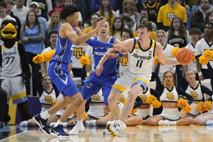 Dec 30, 2023; Milwaukee, Wisconsin, USA;  Marquette Golden Eagles guard Tyler Kolek (11) looks to pass the ball while under pressure from Creighton Bluejays guard Trey Alexander (23) during the first half at Fiserv Forum. Mandatory Credit: Jeff Hanisch-USA TODAY Sports
