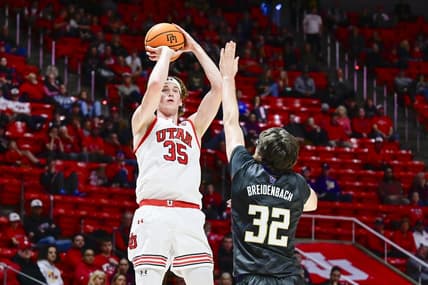 Dec 31, 2023; Salt Lake City, Utah, USA; Utah Utes center Branden Carlson (35) takes a shot over Washington Huskies forward Wilhelm Breidenbach (32) during the first half at the the Jon M. Huntsman Center. Mandatory Credit: Christopher Creveling-USA TODAY Sports