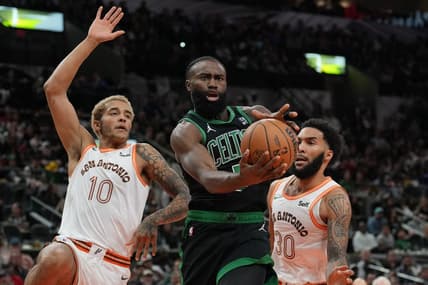 Dec 31, 2023; San Antonio, Texas, USA;  Boston Celtics guard Jaylen Brown (7) loses the ball in front of San Antonio Spurs forwards Jeremy Sochan (10) Julian Champagnie (30) in the first half at Frost Bank Center. Mandatory Credit: Daniel Dunn-USA TODAY Sports