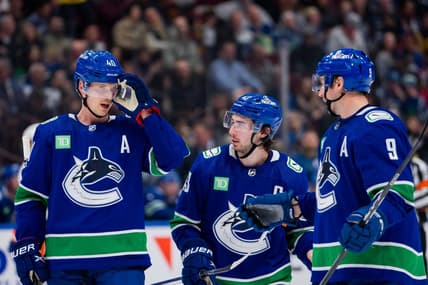 Nov 15, 2023; Vancouver, British Columbia, CAN; Vancouver Canucks forward Elias Pettersson (40) and defenseman Quinn Hughes (43) and forward J.T. Miller (9) discuss face off strategy against the New York Islanders in the third period at Rogers Arena. Vancouver won 4-3 in overtime. Mandatory Credit: Bob Frid-USA TODAY Sports