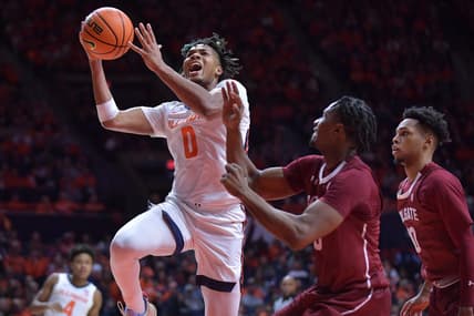 Dec 17, 2023; Champaign, Illinois, USA;  Illinois Fighting Illini guard Terrence Shannon Jr. (0) drives to the basket against Colgate Raiders players during the first half at State Farm Center. Mandatory Credit: Ron Johnson-USA TODAY Sports