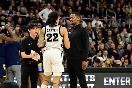 Dec 19, 2023; Providence, Rhode Island, USA; Providence Friars coach Kim English checks on an injured guard Devin Carter (22) during the first half against the Marquette Golden Eagles at Amica Mutual Pavilion. Mandatory Credit: Eric Canha-USA TODAY Sports