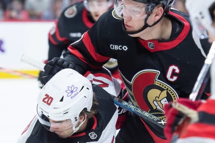 Dec 29, 2023; Ottawa, Ontario, CAN; New Jersey Devils center Michael McLeod (20) faces off against Ottawa Senators left wing Brady Tkachuk (7) in the first period at the Canadian Tire Centre. Mandatory Credit: Marc DesRosiers-USA TODAY Sports