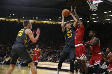Iowa's Owen Freeman (32) drives to the basket against Northern Illinois Friday, Dec. 29, 2023 at Carver-Hawkeye Arena in Iowa City, Iowa.