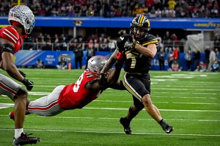 Dec 29, 2023; Arlington, TX, USA; Missouri Tigers running back Cody Schrader (7) runs for a first down against the Ohio State Buckeyes during the fourth quarter at AT&T Stadium. Mandatory Credit: Jerome Miron-USA TODAY Sports