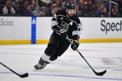 Dec 30, 2023; Los Angeles, California, USA; Los Angeles Kings center Phillip Danault (24) moces the puck against the Edmonton Oilers during the second period at Crypto.com Arena. Mandatory Credit: Gary A. Vasquez-USA TODAY Sports