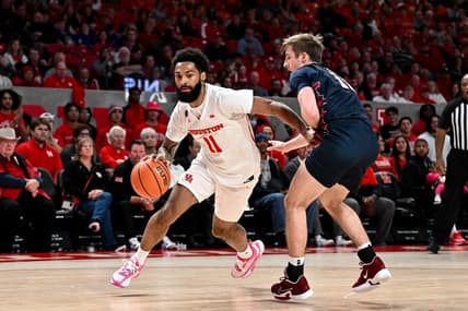 Dec 30, 2023; Houston, Texas, USA; Houston Cougars guard Damian Dunn (11) drives to the basket as Pennsylvania Quakers guard Sam Brown (11) defends during the first half at Fertitta Center. Mandatory Credit: Maria Lysaker-USA TODAY Sports