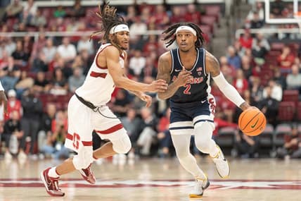 Dec 31, 2023; Stanford, California, USA; Arizona Wildcats guard Caleb Love (2) drives the ball during the second half against Stanford Cardinal guard Kanaan Carlyle (3) at Maples Pavilion. Mandatory Credit: Stan Szeto-USA TODAY Sports