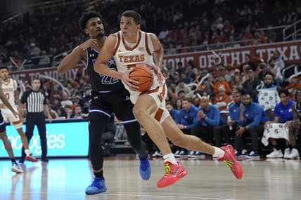 Jan 1, 2024; Austin, Texas, USA; Texas Longhorns forward Kadin Shedrick (5) drives to the basket while defended by Texas-Arlington Mavericks forward Shemar Wilson (22) during the first half at Moody Center. Mandatory Credit: Scott Wachter-USA TODAY Sports