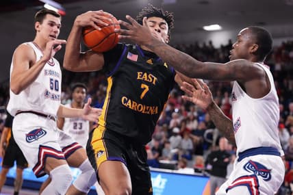 Jan 2, 2024; Boca Raton, Florida, USA; East Carolina Pirates guard Quentin Diboundje (7) dribbles against Florida Atlantic Owls guard Johnell Davis (1) during the first half at Eleanor R. Baldwin Arena. Mandatory Credit: Rich Storry-USA TODAY Sports