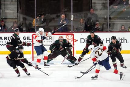 Jan 2, 2024; Tempe, Arizona, USA; Florida Panthers center Eetu Luostarinen (27) shoots against Arizona Coyotes goaltender Karel Vejmelka (70) during the second period at Mullett Arena. Mandatory Credit: Joe Camporeale-USA TODAY Sports
