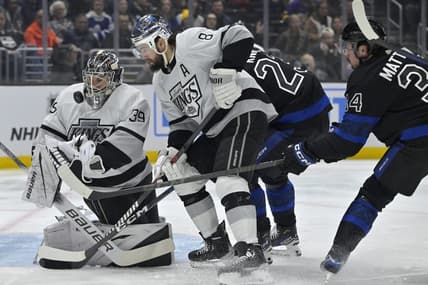 Jan 2, 2024; Los Angeles, California, USA; Los Angeles Kings goaltender Cam Talbot (39) makes a save off a shot by Toronto Maple Leafs left wing Matthew Knies (23) as Los Angeles Kings defenseman Drew Doughty (8) defends in the first period at Crypto.com Arena. Mandatory Credit: Jayne Kamin-Oncea-USA TODAY Sports