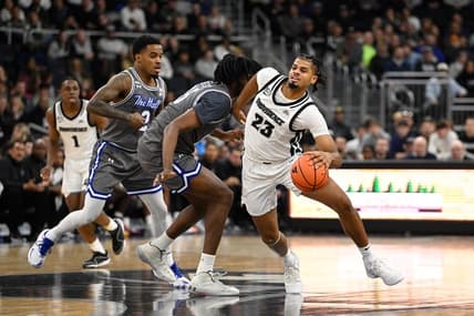Jan 3, 2024; Providence, Rhode Island, USA; Providence Friars forward Bryce Hopkins (23) drives the ball through Seton Hall Pirates center Jaden Bediako (15) during the first half at Amica Mutual Pavilion. Mandatory Credit: Eric Canha-USA TODAY Sports