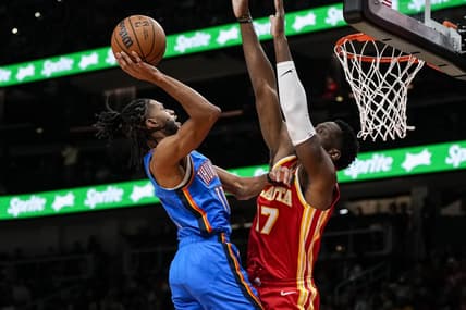 Jan 3, 2024; Atlanta, Georgia, USA; Oklahoma City Thunder guard Isaiah Joe (11) shoots against Atlanta Hawks forward Onyeka Okongwu (17) during the first half at State Farm Arena. Mandatory Credit: Dale Zanine-USA TODAY Sports