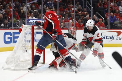 Jan 3, 2024; Washington, District of Columbia, USA; New Jersey Devils goaltender Nico Daws (50) makes a save in front of Washington Capitals center Aliaksei Protas (21) and Devils defenseman Brendan Smith (2) in the first period at Capital One Arena. Mandatory Credit: Geoff Burke-USA TODAY Sports
