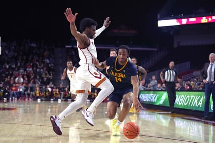 Jan 3, 2024; Los Angeles, California, USA; California Golden Bears forward Grant Newell (14) dribbles against Southern California Trojans guard Bronny James (6)  in the first half at Galen Center. Mandatory Credit: Kirby Lee-USA TODAY Sports