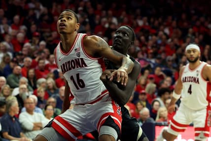 Jan 4, 2024; Tucson, Arizona, USA; Arizona Wildcats forward Keshad Johnson (16) and Colorado Buffaloes forward Bangot Dak (12) go for a rebound during the first half at McKale Center. Mandatory Credit: Zachary BonDurant-USA TODAY Sports