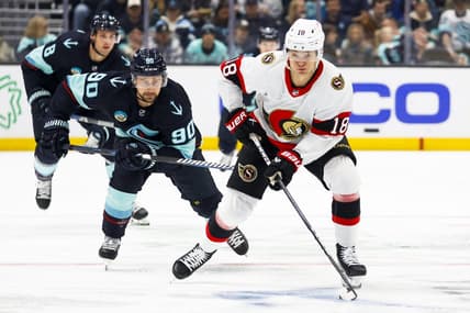 Jan 4, 2024; Seattle, Washington, USA; Ottawa Senators center Tim Stutzle (18) skates with the puck ahead of Seattle Kraken left wing Tomas Tatar (90) during the first period at Climate Pledge Arena. Mandatory Credit: Joe Nicholson-USA TODAY Sports