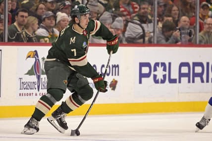 Jan 4, 2024; Saint Paul, Minnesota, USA; Minnesota Wild defenseman Brock Faber (7) makes a pass against the Tampa Bay Lightning during the third period at Xcel Energy Center. Mandatory Credit: Nick Wosika-USA TODAY Sports
