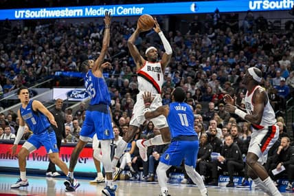 Jan 5, 2024; Dallas, Texas, USA; Portland Trail Blazers forward Jerami Grant (9) passes the ball over Dallas Mavericks forward Derrick Jones Jr. (55) and guard Kyrie Irving (11) during the second quarter at the American Airlines Center. Mandatory Credit: Jerome Miron-USA TODAY Sports