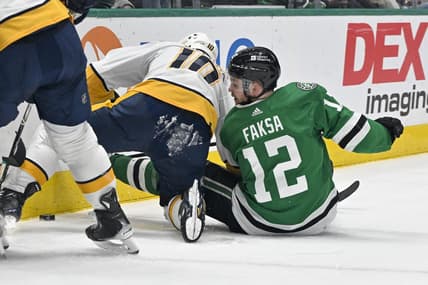 Jan 6, 2024; Dallas, Texas, USA; Nashville Predators center Colton Sissons (10) and Dallas Stars center Radek Faksa (12) battle for control of the puck along the boards during the second period at the American Airlines Center. Mandatory Credit: Jerome Miron-USA TODAY Sports