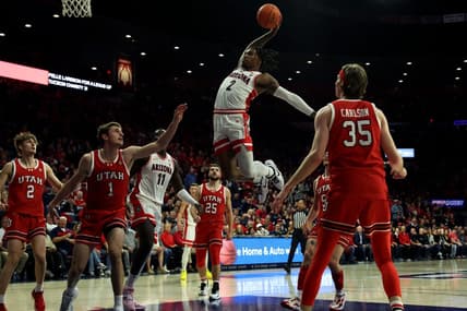Jan 6, 2024; Tucson, Arizona, USA; Arizona Wildcats guard Caleb Love (2) makes a basket against Utah Utes forward Ben Carlson (1) during the second half at McKale Center. Mandatory Credit: Zachary BonDurant-USA TODAY Sports