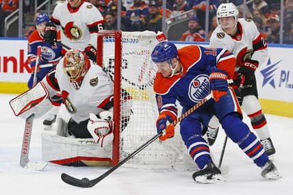 Jan 6, 2024; Edmonton, Alberta, CAN; Edmonton Oilers forward Zach Hyman (18) controls the puck against Ottawa Senators goaltender Anton Forsberg (31) during the first period at Rogers Place. Mandatory Credit: Perry Nelson-USA TODAY Sports