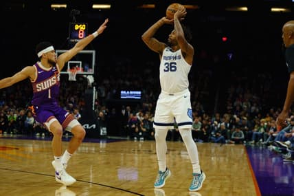 Jan 7, 2024; Phoenix, Arizona, USA;  Memphis Grizzlies guard Marcus Smart (36) squares up against Phoenix Suns guard Devin Booker (1) during the first quarter at Footprint Center. Mandatory Credit: Allan Henry-USA TODAY Sports