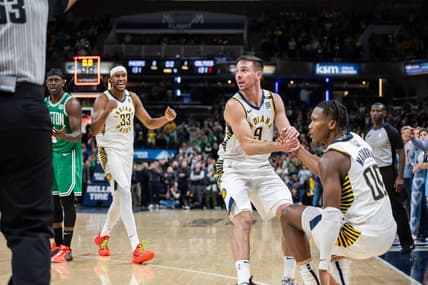 Jan 8, 2024; Indianapolis, Indiana, USA; Indiana Pacers guard T.J. McConnell (9) helps up Indiana Pacers guard Bennedict Mathurin (00) after a foul  in the second half against the Boston Celtics at Gainbridge Fieldhouse. Mandatory Credit: Trevor Ruszkowski-USA TODAY Sports