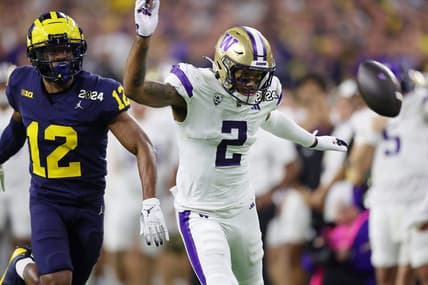 Jan 8, 2024; Houston, TX, USA; Michigan Wolverines defensive back Josh Wallace (12) and Washington Huskies wide receiver Ja'Lynn Polk (2) are unable to catch a pass during the third quarter in the 2024 College Football Playoff national championship game at NRG Stadium. Mandatory Credit: Thomas Shea-USA TODAY Sports