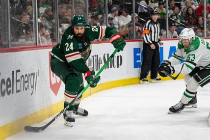 Jan 8, 2024; Saint Paul, Minnesota, USA; Minnesota Wild defenseman Zach Bogosian (24) clears the puck, pressed by Dallas Stars right wing Evgenii Dadonov (63) in the third period at Xcel Energy Center. Mandatory Credit: Matt Blewett-USA TODAY Sports