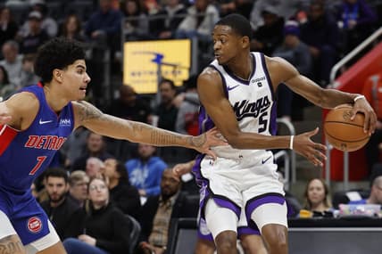 Jan 9, 2024; Detroit, Michigan, USA;  Sacramento Kings guard De'Aaron Fox (5) dribbles defended by Detroit Pistons guard Killian Hayes (7) in the first half at Little Caesars Arena. Mandatory Credit: Rick Osentoski-USA TODAY Sports