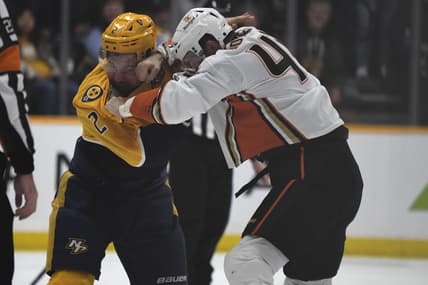 Jan 9, 2024; Nashville, Tennessee, USA; Nashville Predators defenseman Luke Schenn (2) and Anaheim Ducks left wing Ross Johnston (44) exchange punches doing a fight during the first period at Bridgestone Arena. Mandatory Credit: Christopher Hanewinckel-USA TODAY Sports