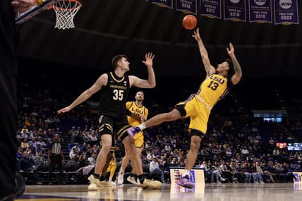 Jan 9, 2024; Baton Rouge, Louisiana, USA; LSU Tigers forward Jalen Reed (13) shoots a jump shot against Vanderbilt Commodores forward Carter Lang (35) during the first half at Pete Maravich Assembly Center. Mandatory Credit: Stephen Lew-USA TODAY Sports