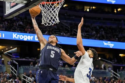 Jan 9, 2024; Orlando, Florida, USA; Orlando Magic forward Paolo Banchero (5) dunks against Minnesota Timberwolves center Karl-Anthony Towns (32) during the second half at KIA Center. Mandatory Credit: Mike Watters-USA TODAY Sports