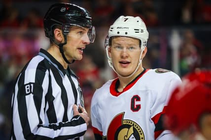 Jan 9, 2024; Calgary, Alberta, CAN; Ottawa Senators left wing Brady Tkachuk (7) and linesman Ryan Daisy (81) exchange words during the second period against the Calgary Flames at Scotiabank Saddledome. Mandatory Credit: Sergei Belski-USA TODAY Sports