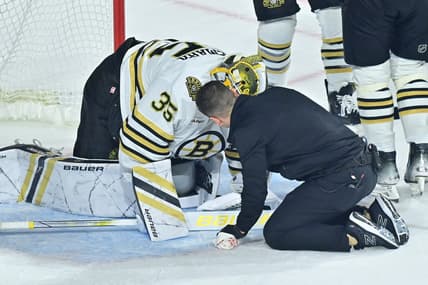 Jan 9, 2024; Tempe, Arizona, USA; Boston Bruins goaltender Linus Ullmark (35) is checked by an athletic trainer during overtime against the Arizona Coyotes at Mullett Arena. Mandatory Credit: Matt Kartozian-USA TODAY Sports
