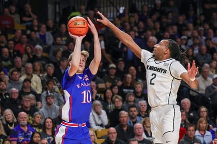 Jan 10, 2024; Orlando, Florida, USA; Kansas Jayhawks guard Johnny Furphy (10) shoots a three point basket against UCF Knights guard Shemarri Allen (2) during the first period against the UCF Knights at Addition Financial Arena. Mandatory Credit: Mike Watters-USA TODAY Sports
