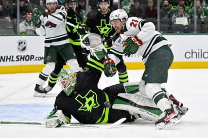 Jan 10, 2024; Dallas, Texas, USA; Minnesota Wild right wing Brandon Duhaime (21) is hit by a Wild slap shot as he attempts a shot on Dallas Stars goaltender Scott Wedgewood (41) during the first period at the American Airlines Center. Mandatory Credit: Jerome Miron-USA TODAY Sports