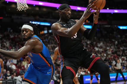 Jan 10, 2024; Miami, Florida, USA; Miami Heat center Bam Adebayo (13) grabs a loose ball as Oklahoma City Thunder guard Luguentz Dort (5) defends during the first half at Kaseya Center. Mandatory Credit: Jim Rassol-USA TODAY Sports